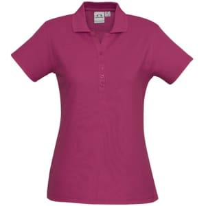 A pink ladies polo shirt with a classic collar, short sleeves, and a button placket. Features a logo on the front.
