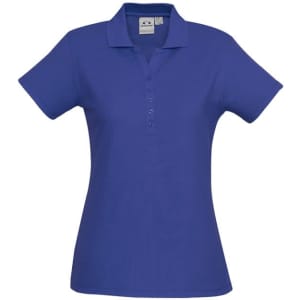 A blue ladies' polo shirt with a collared neckline and short sleeves, featuring a logo.
