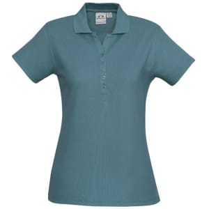 A teal polo shirt for ladies with a collar and button placket, featuring a logo on the label.