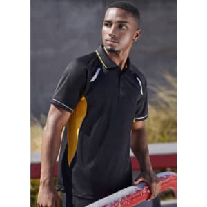 A black and yellow short sleeve polo shirt featuring a logo and contrasting panels. The model stands outdoors.