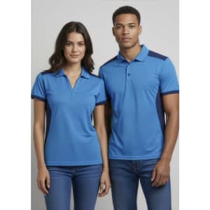 A women's short sleeve polo shirt in blue with navy accents, featuring a collar and a logo.