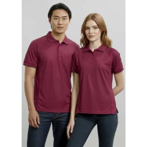 A burgundy women's short sleeve polo shirt with a collar, featuring a logo, styled on a model.
