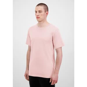 A light pink men's short sleeve t-shirt displayed on a model, featuring a plain design and a logo.
