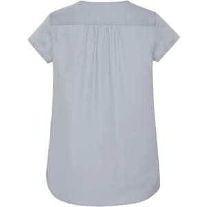 A light blue women's blouse featuring a V-neck and pleat detailing at the back. Includes a logo.