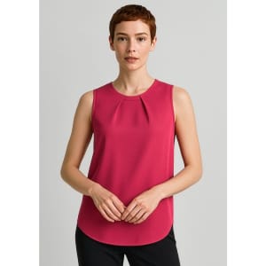 A sleeveless blouse in a vibrant pink with pleat detail. Model poses against a neutral background, wearing black trousers.