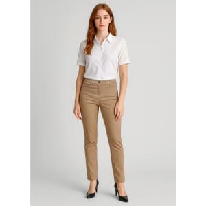 A woman stands wearing beige slim leg stretch chino pants and a white blouse, paired with black heels.
