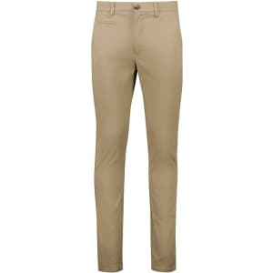 A pair of tan tapered stretch chino pants with a front pocket and a button closure.