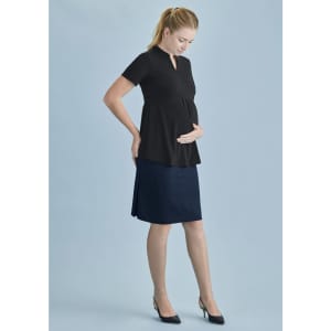 A maternity skirt in navy blue, paired with a black top. The model displays a casual, stylish look.