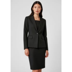 A black mid-length women's blazer with a single button, styled with a matching fitted skirt, featuring pockets and a logo.