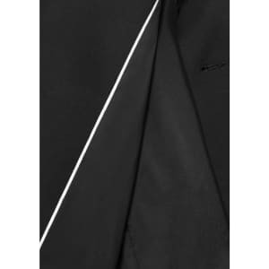 A close-up of the inside lining of a black jacket featuring a contrasting white trim and a sleek design.