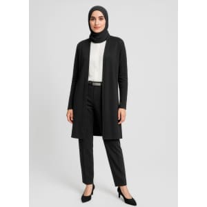 A longline cardigan in black, paired with a white blouse and black trousers, worn by a woman in a hijab.