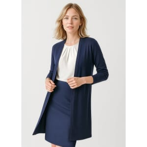 A longline cardigan in navy, featuring an open front and long sleeves, paired with a blouse and skirt.