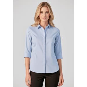 A light blue women's button-up shirt with 3/4 sleeves, featuring a collar and a branding logo.