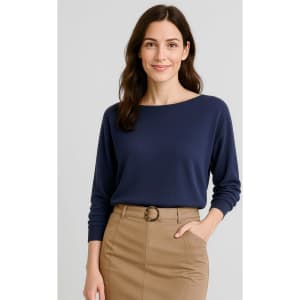 A navy batwing sweater top on a model, paired with a tan skirt. The image features a logo on the clothing.