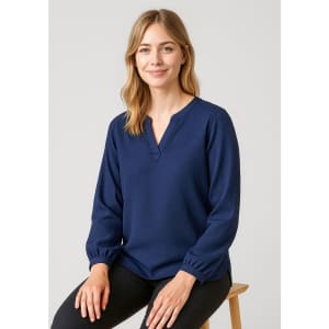 A navy long sleeve blouse with a V-neck and gathered sleeves, worn by a seated model.