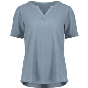 A short sleeve blouse in light blue, featuring a V-neck and a relaxed fit. It has a subtle ruché texture and a logo.