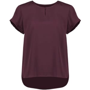 A short sleeve blouse in burgundy with a keyhole detail at the neckline and a rounded hem. It features rolled sleeves and a logo.