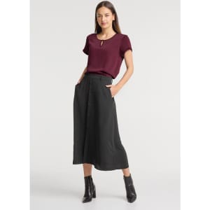 A maroon short sleeve blouse paired with a black skirt. The outfit features a keyhole neckline and side pockets.