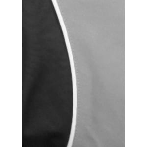 A black and grey short sleeve shirt featuring a curved design and contrast piping, with a logo displayed.