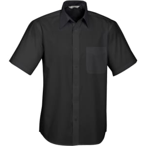 A short sleeve button-up shirt in black featuring a patch pocket and a collar. The shirt has a logo on it.