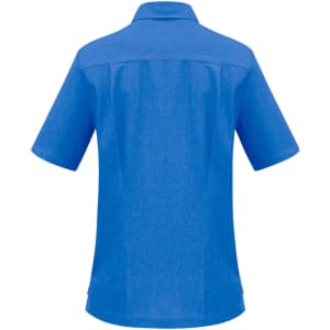 A blue overblouse with short sleeves and a collar, featuring a back yoke and subtle texture. It includes a logo.