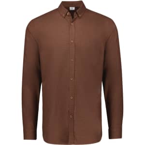 A brown long sleeve button-up shirt featuring a collar and a single chest pocket, with a logo on the label.