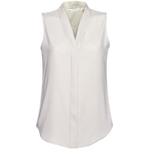 A sleeveless, light cream women's top with a v-neck and soft fabric. Features a branding logo.