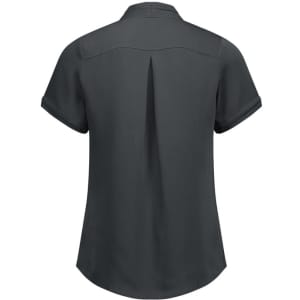 A women's short sleeve button-up shirt in dark grey, featuring a back pleat and rolled cuffs. It has a logo.