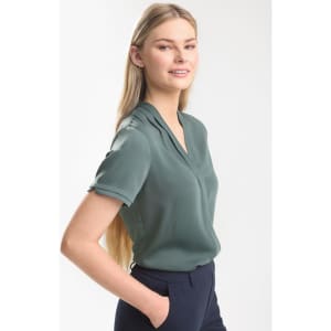 A women's short sleeve button-up shirt in a soft green colour, featuring a collar and a relaxed fit.