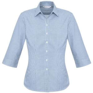 A women's 3/4 sleeve button-up shirt in a light blue check pattern, featuring a classic collar and a logo.
