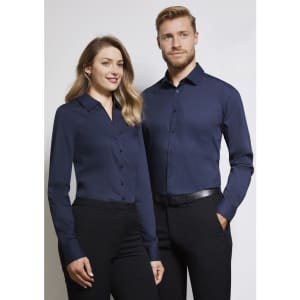 A women's long sleeve button-up shirt in navy, displayed by a model alongside a man in a matching shirt.