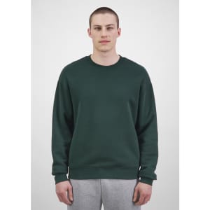 A green men's everyday crew sweatshirt displayed on a model, featured with a plain design and a logo.