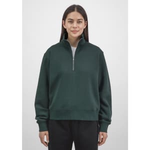 A women's dark green 1/4 zip sweatshirt with a relaxed fit and a branded logo.