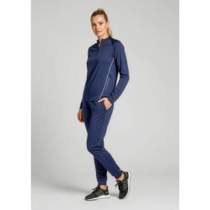 A woman wearing a navy blue unisex mid-layer top with long sleeves and matching pants, standing against a plain background.