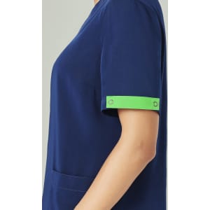 A navy blue scrub top with short sleeves featuring a bright green arm band and a pocket.