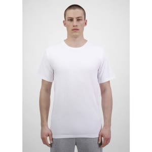 A plain white short sleeve tee displayed on a model, featuring a simple design and a casual fit.