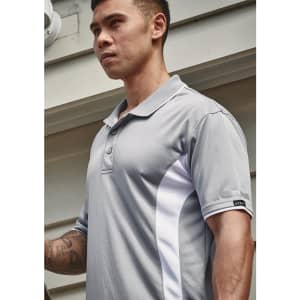 A grey short sleeve polo featuring white accents and a logo on the sleeve. The model is standing outdoors.