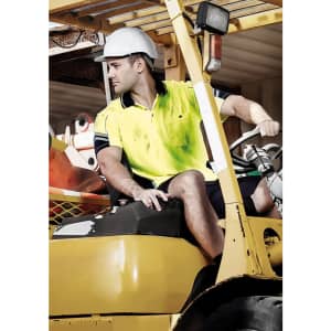 Hi-vis short sleeve polo in yellow and navy worn by a man sitting on a forklift, with a hard hat on.