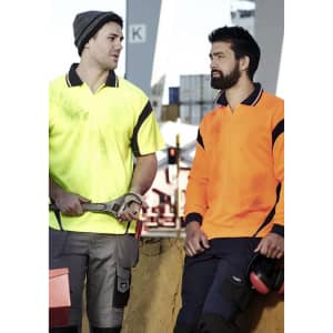 Two men in high visibility polo shirts, one in yellow and the other in orange, in a work environment.