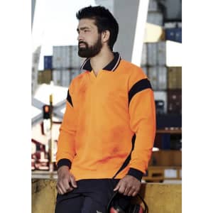 A long sleeve polo shirt in bright orange with navy accents, featuring a logo and worn by a man at a worksite.