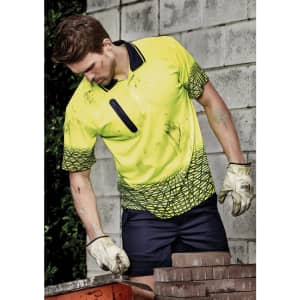 A bright yellow short sleeve polo shirt with a geometric pattern, worn by a male model working with bricks.