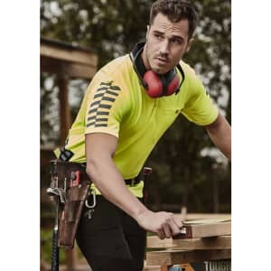 A Hi Vis yellow short sleeve polo shirt worn by a man, featuring a logo and dark accents, designed for workwear.