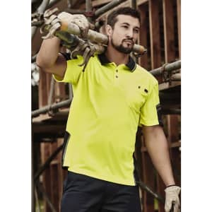 A bright yellow short sleeve polo shirt with reinforced detailing, featuring a pocket and logo, worn by a man.