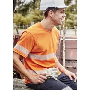 An orange hi-visibility cotton tee with segmented reflective tape, worn by a man in a hard hat, sitting outdoors.