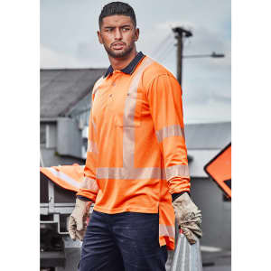 A long sleeve polo shirt in high-visibility orange with silver segmented reflective tape, worn by a model outdoors.