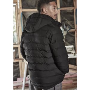 A black unisex hooded puffer jacket with a quilted design, worn by a person from a side angle.