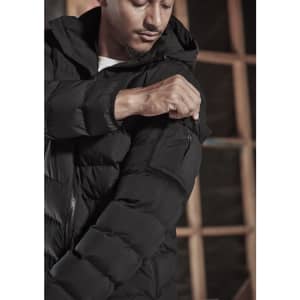 A black unisex puffer jacket with a hood, featuring a zip-up front and a pocket on the arm.
