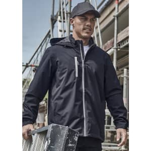 A man wearing a black unisex packable rain jacket, holding a metal ladder, with construction scaffolding in the background.