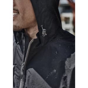 A black unisex packable rain jacket with a hood, featuring water droplets on its surface and a logo detail.