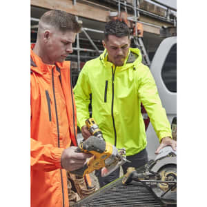 Two men in bright orange and neon yellow rain jackets work on a construction site, using power tools. Both jackets have logos.